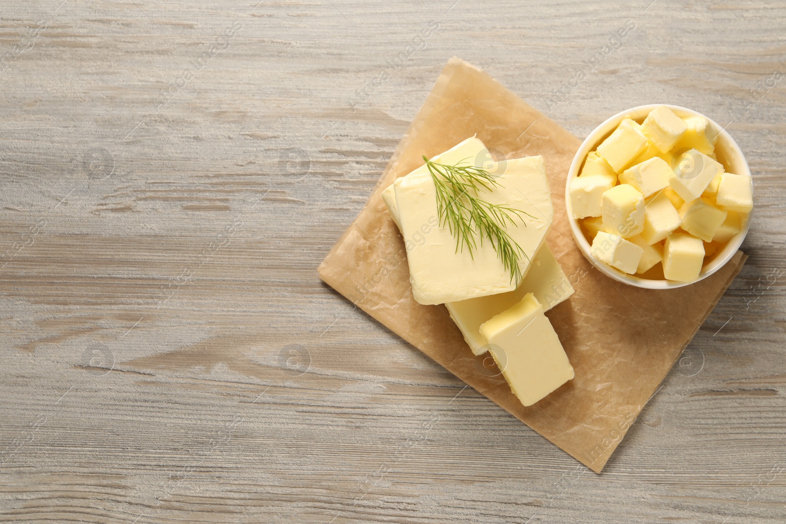 Photo of Tasty butter with dill on wooden table, top view. Space for text