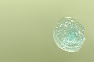 Photo of Sample of cleansing gel on pale green background, top view with space for text. Cosmetic product