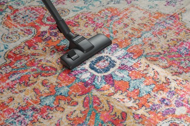 Hoovering carpet with vacuum cleaner, space for text. Clean trace on dirty surface