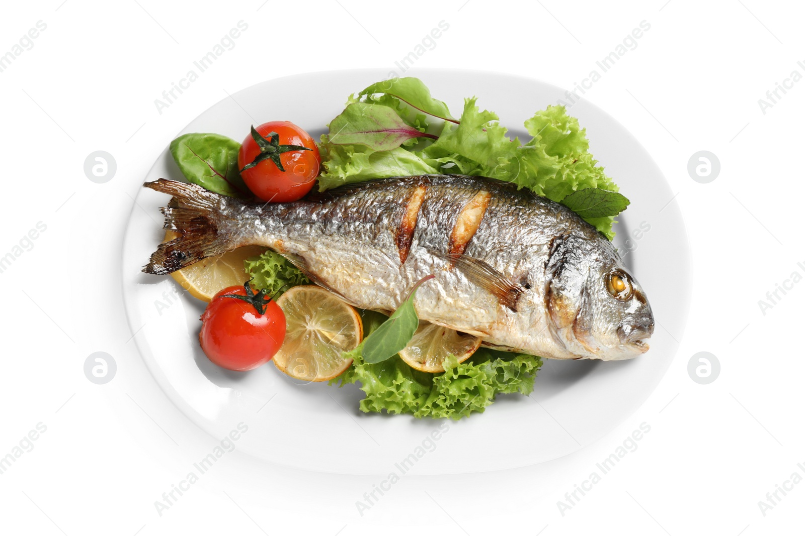 Photo of Delicious roasted fish with lemon and vegetables isolated on white, top view