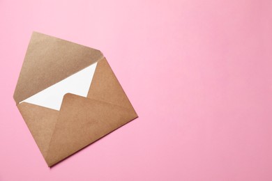 Photo of Letter envelope with card on pink background, top view. Space for text