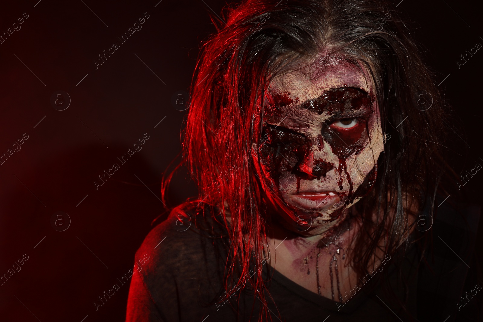 Photo of Scary zombie on dark background, closeup. Halloween monster