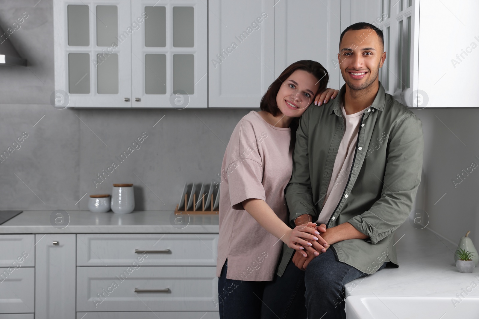 Photo of Dating agency. Happy couple spending time together in kitchen