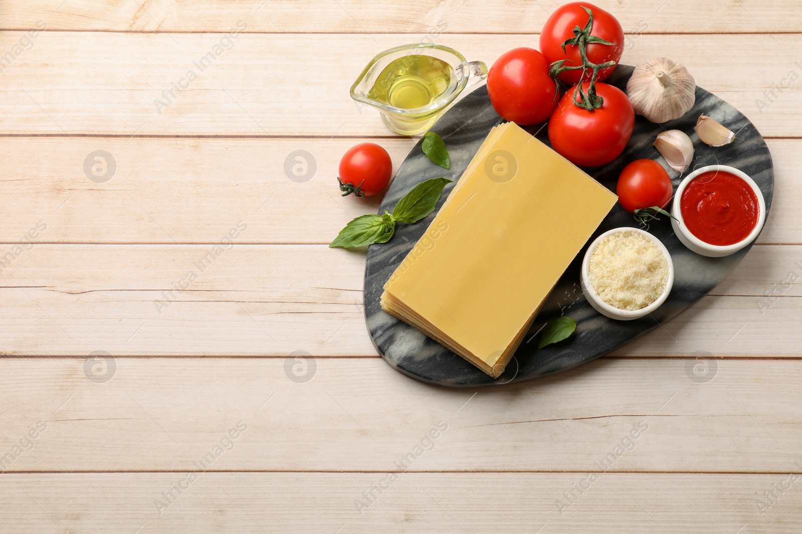 Photo of Ingredients for lasagna on white wooden table, flat lay. Space for text