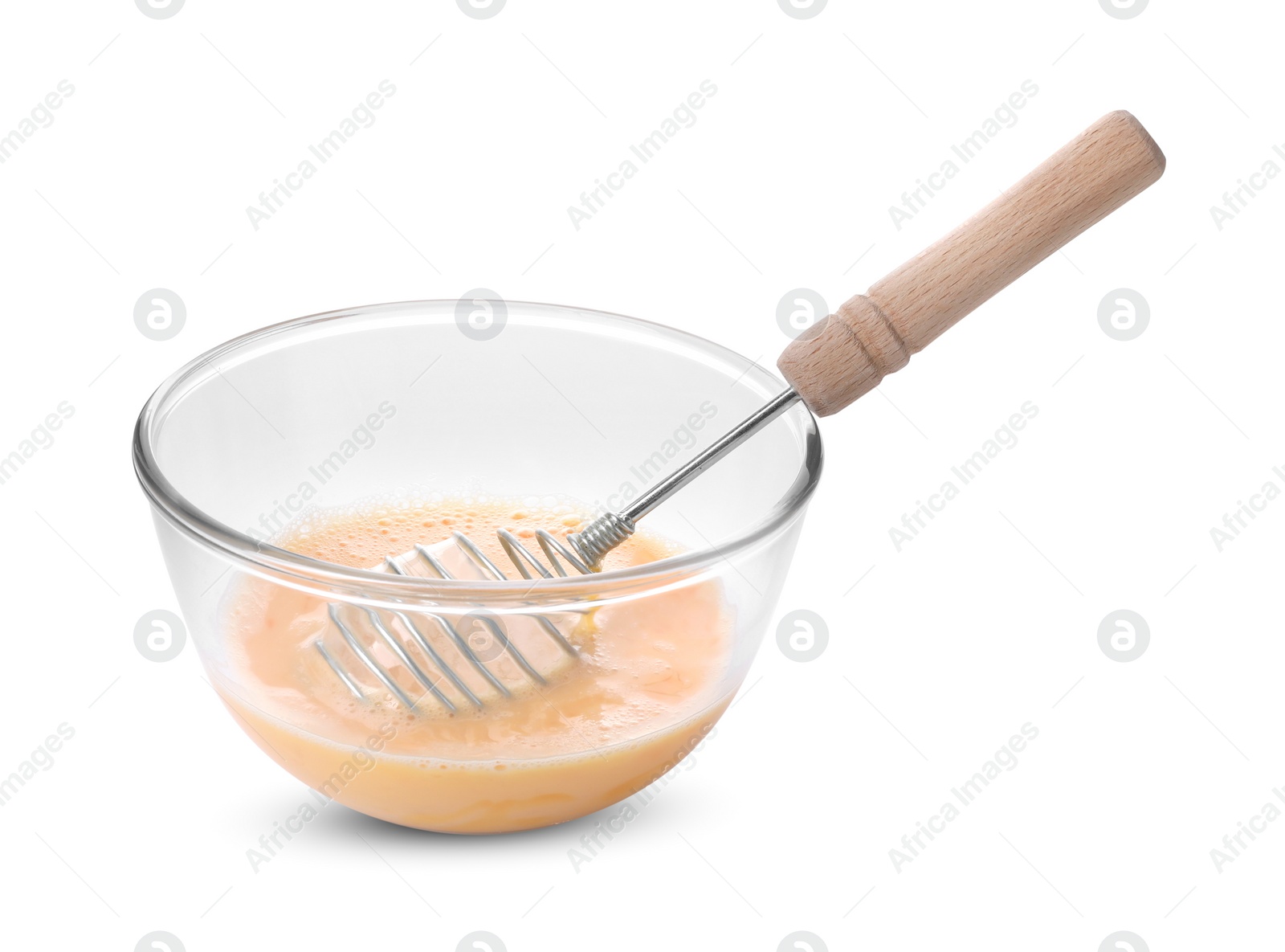 Photo of Beaten eggs and whisk in glass bowl isolated on white