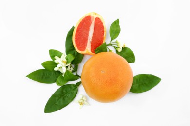 Photo of Fresh ripe grapefruits and green leaves on white background, flat lay