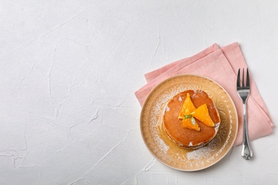 Photo of Plate with tasty pancakes on light background, top view