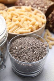 Photo of Chia seeds and different gluten free products on white table