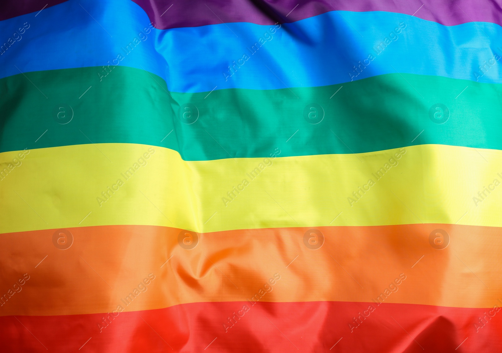 Photo of Bright rainbow gay flag as background. LGBT community