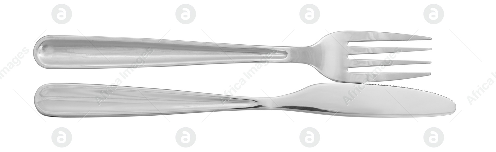 Photo of Knife and fork isolated on white, top view. Stylish shiny cutlery set