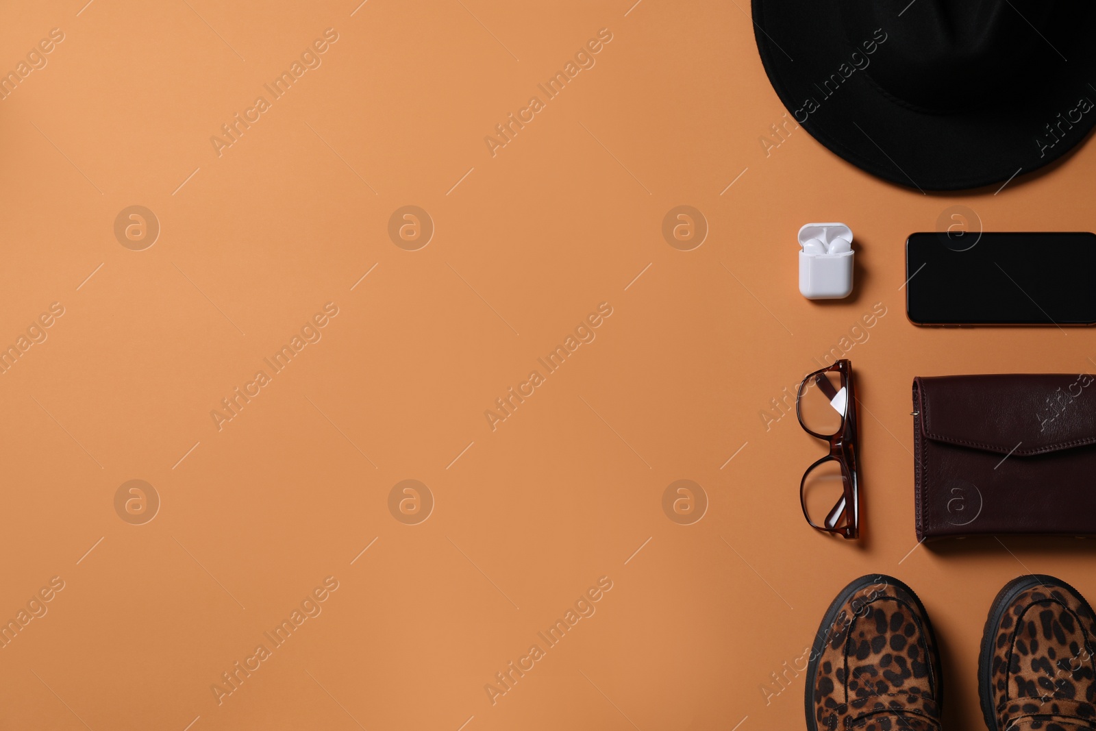 Photo of Flat lay composition with stylish hat on orange background, space for text