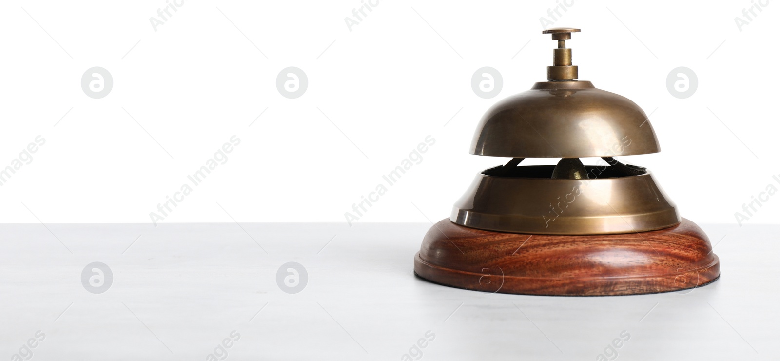 Photo of Hotel service bell on wooden table against white background