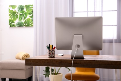 Comfortable workplace with computer on desk in home office