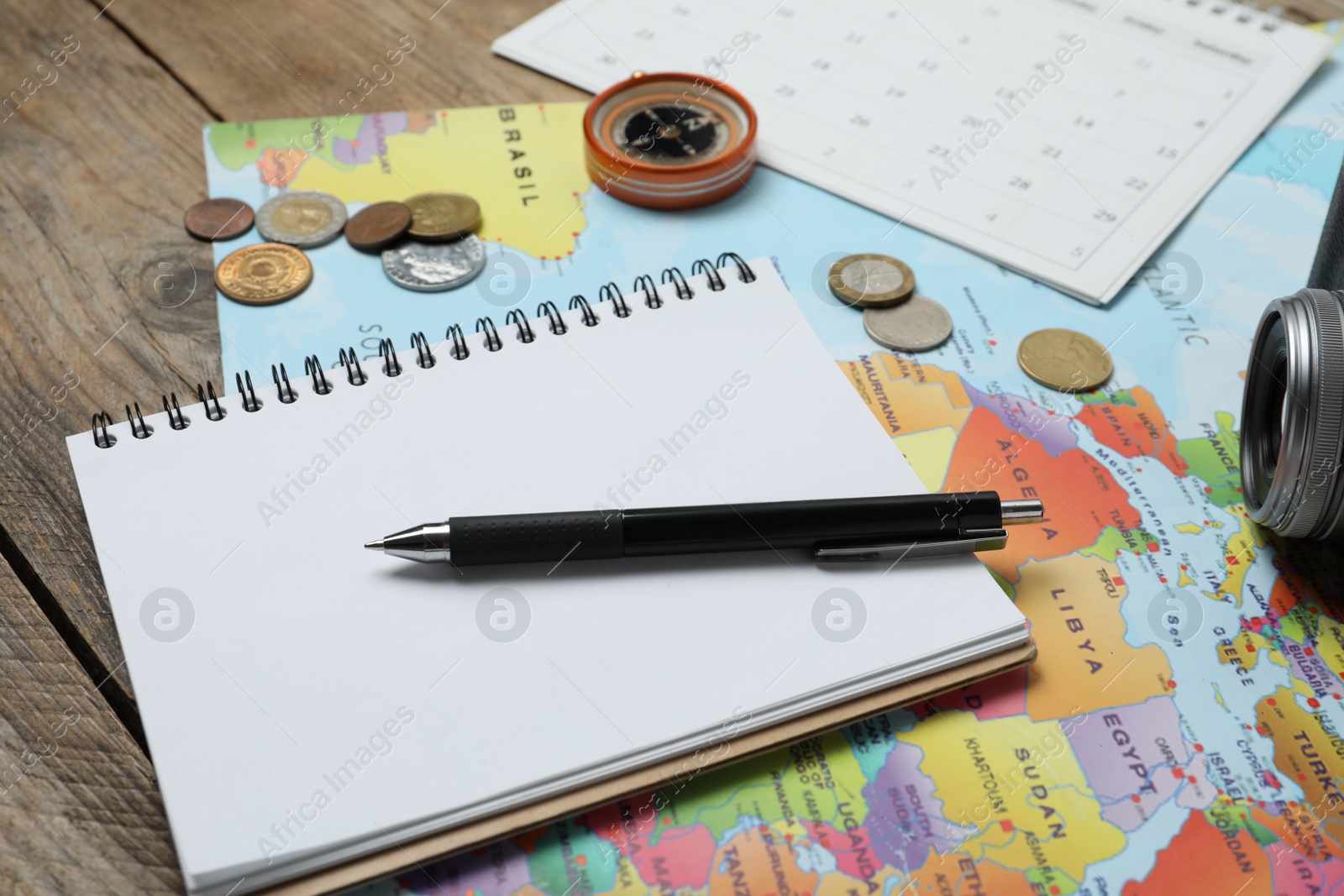 Photo of Different travel accessories on wooden table, closeup. Planning summer vacation trip