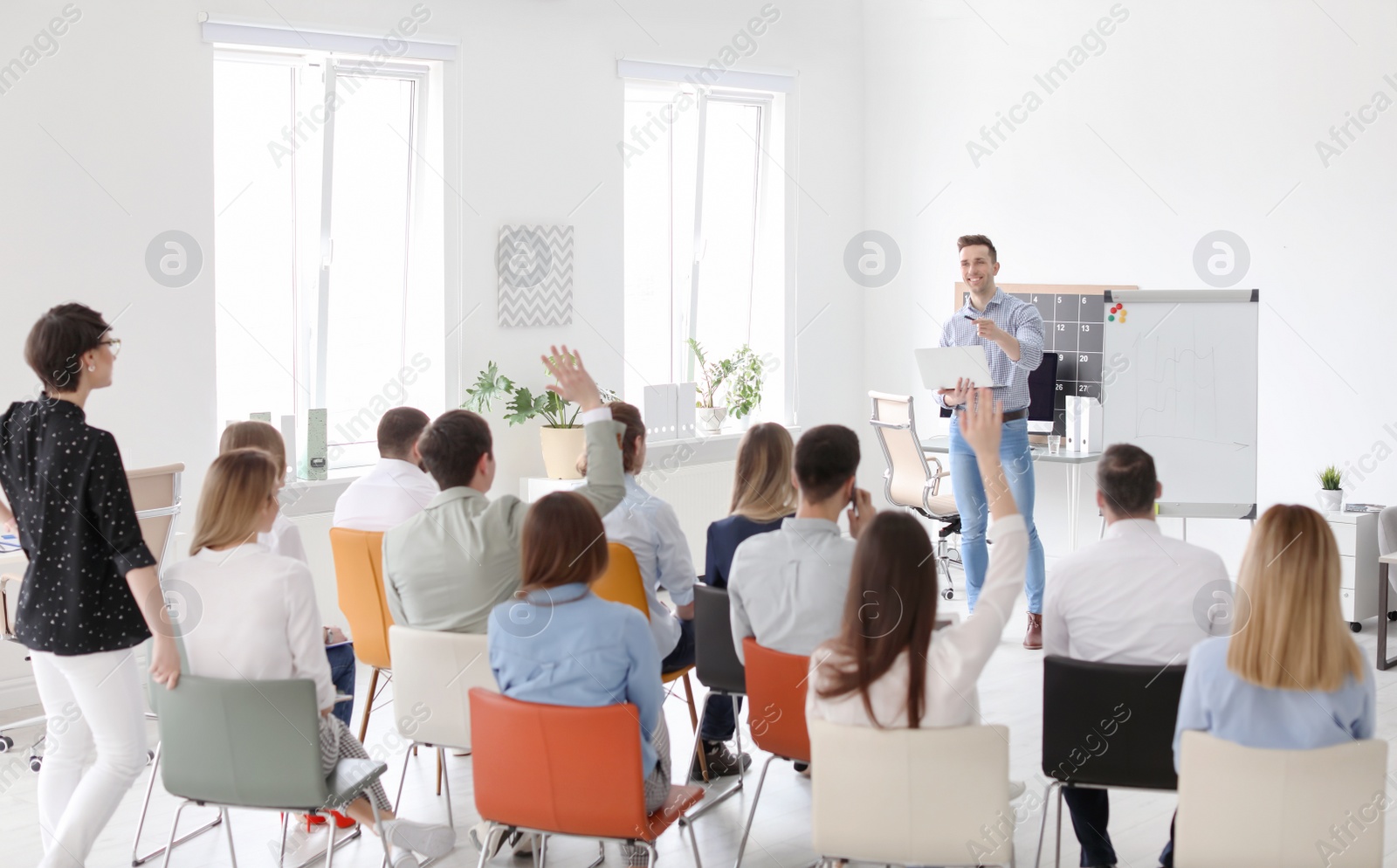 Photo of Male business trainer giving lecture in office