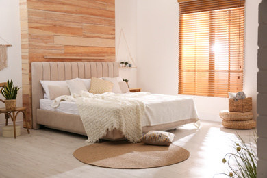 Stylish room interior with big comfortable bed