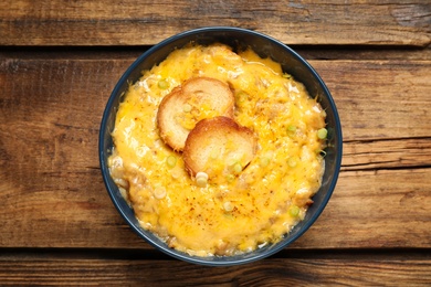 Tasty homemade French onion soup on wooden table, top view