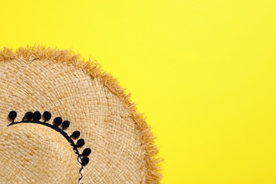 Photo of Stylish straw hat on color background, top view with space for text. Beach accessories