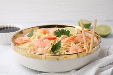 Photo of Tasty spaghetti with shrimps and parsley in bowl on white tiled table, closeup