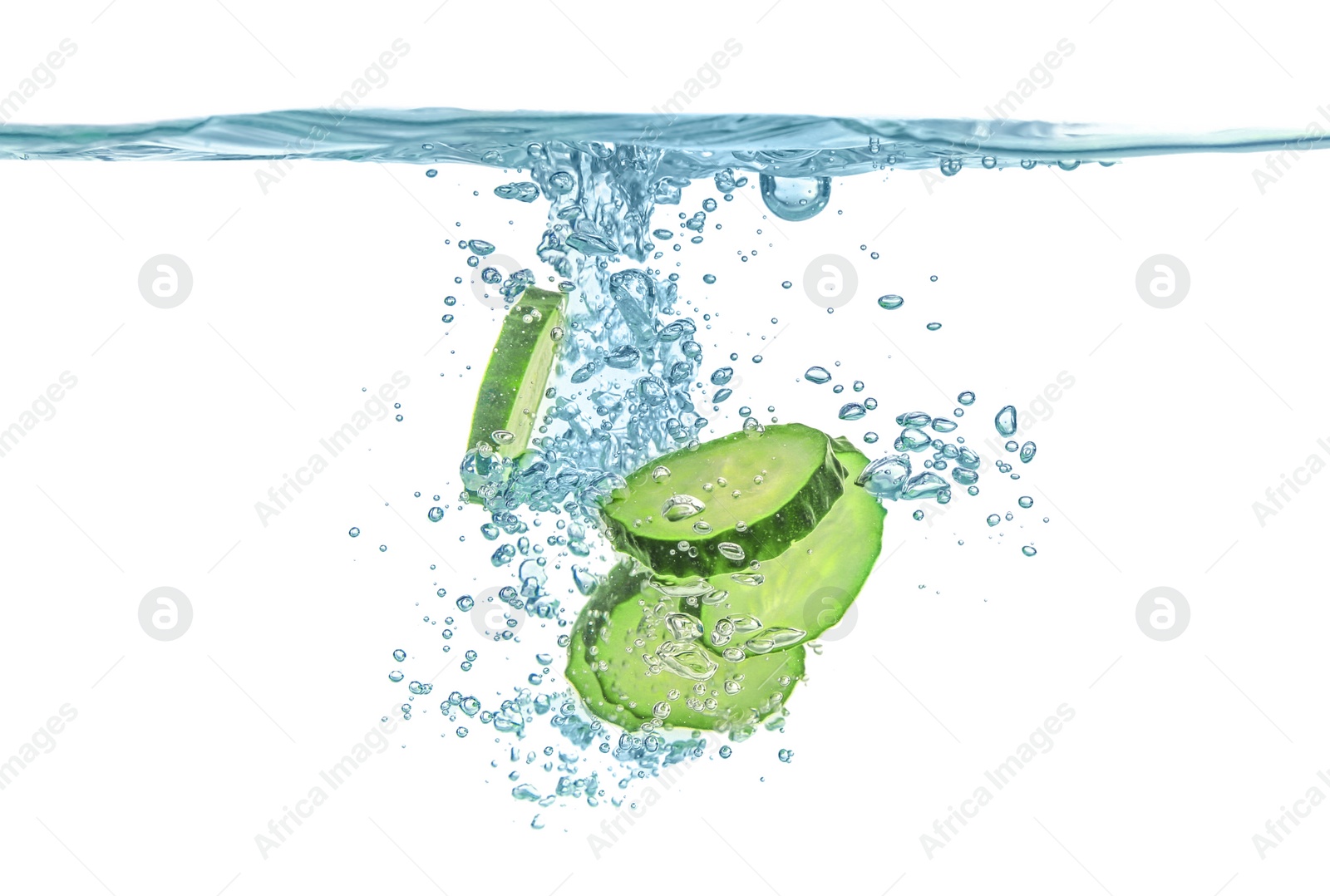 Photo of Fresh cucumber slices in water on white background