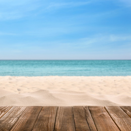 Wooden surface on sandy beach near ocean