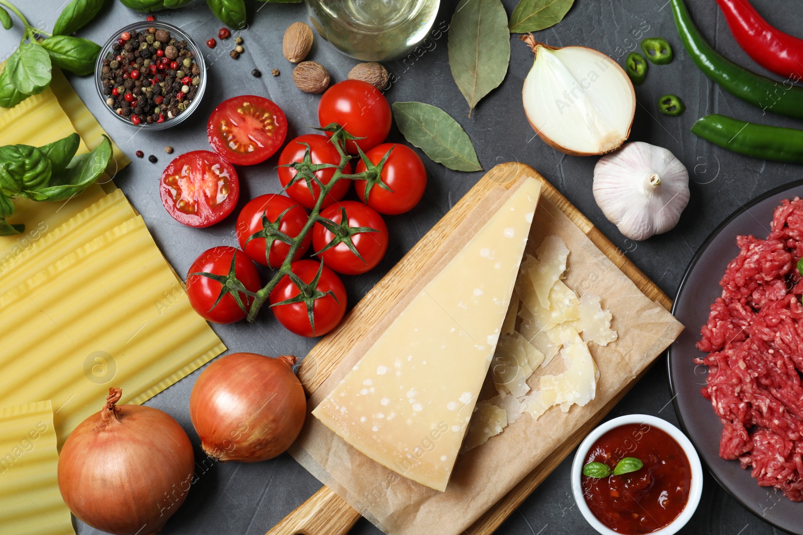 Photo of Fresh ingredients for lasagna on grey table, flat lay