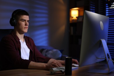 Man playing video games on computer at table indoors