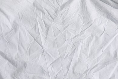 Photo of Crumpled white fabric as background, top view