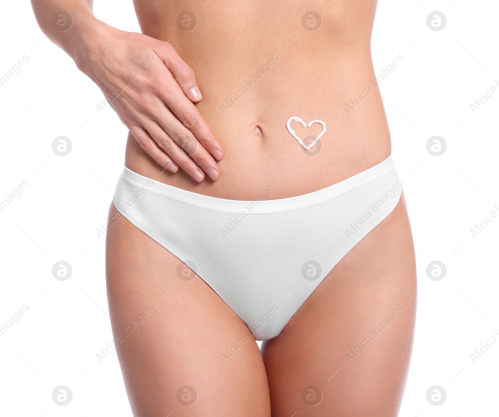 Photo of Woman with body cream onto her belly against white background, closeup