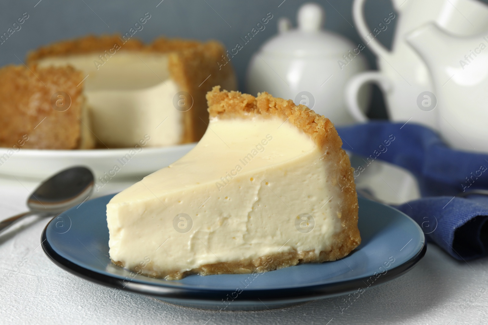 Photo of Piece of tasty vegan tofu cheesecake on white table, closeup