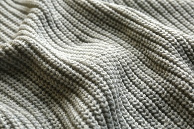 Beautiful grey knitted fabric as background, closeup