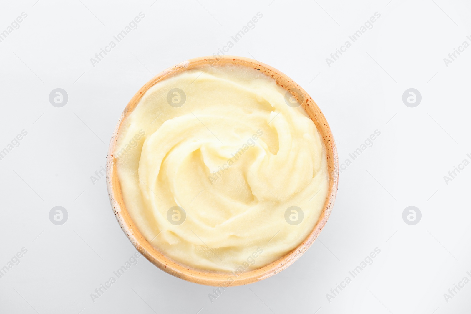 Photo of Bowl with tasty mashed potatoes on white background, top view