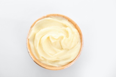 Photo of Bowl with tasty mashed potatoes on white background, top view