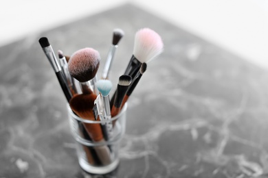 Photo of Holder with makeup brushes on table