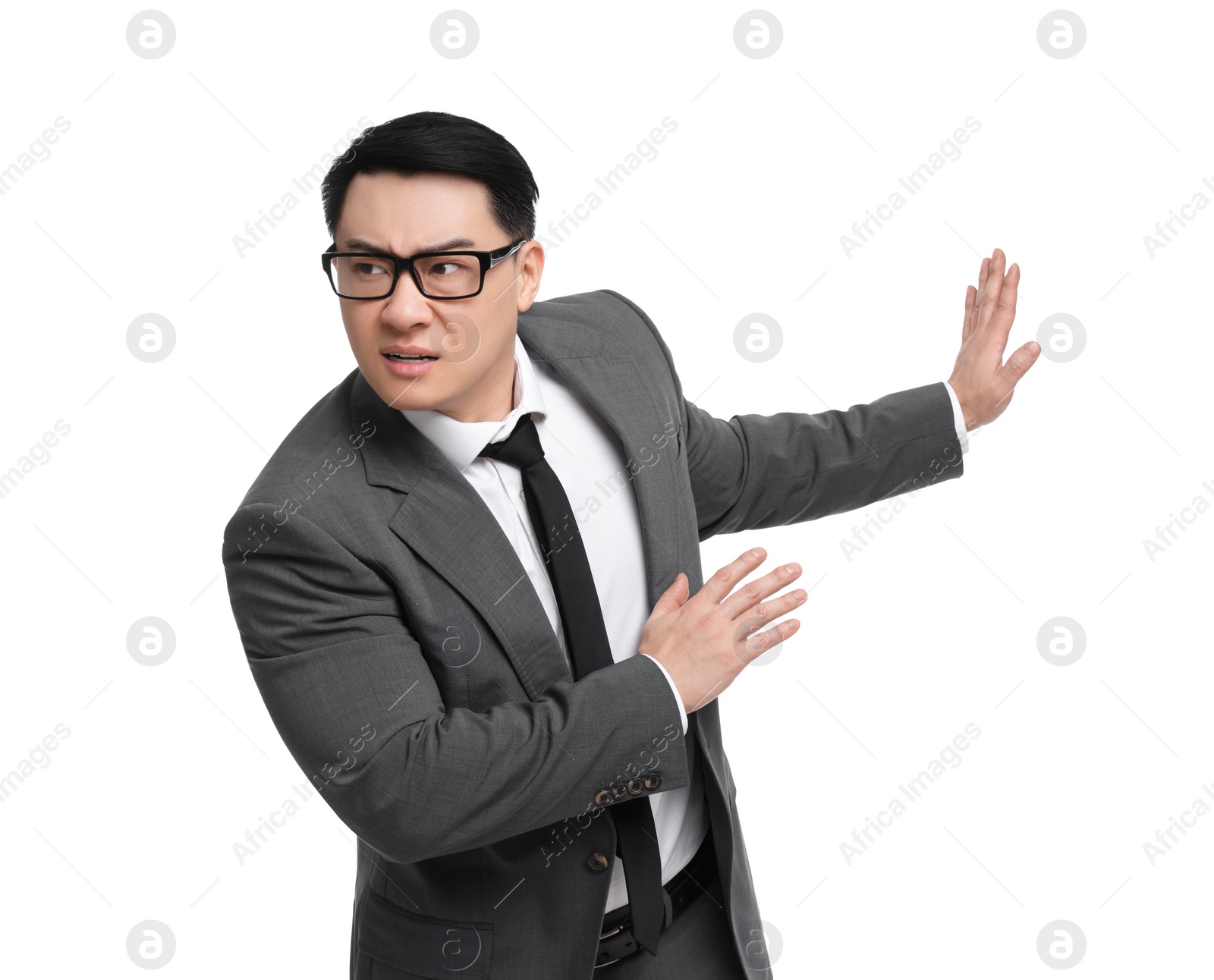 Photo of Scared businessman in suit posing on white background