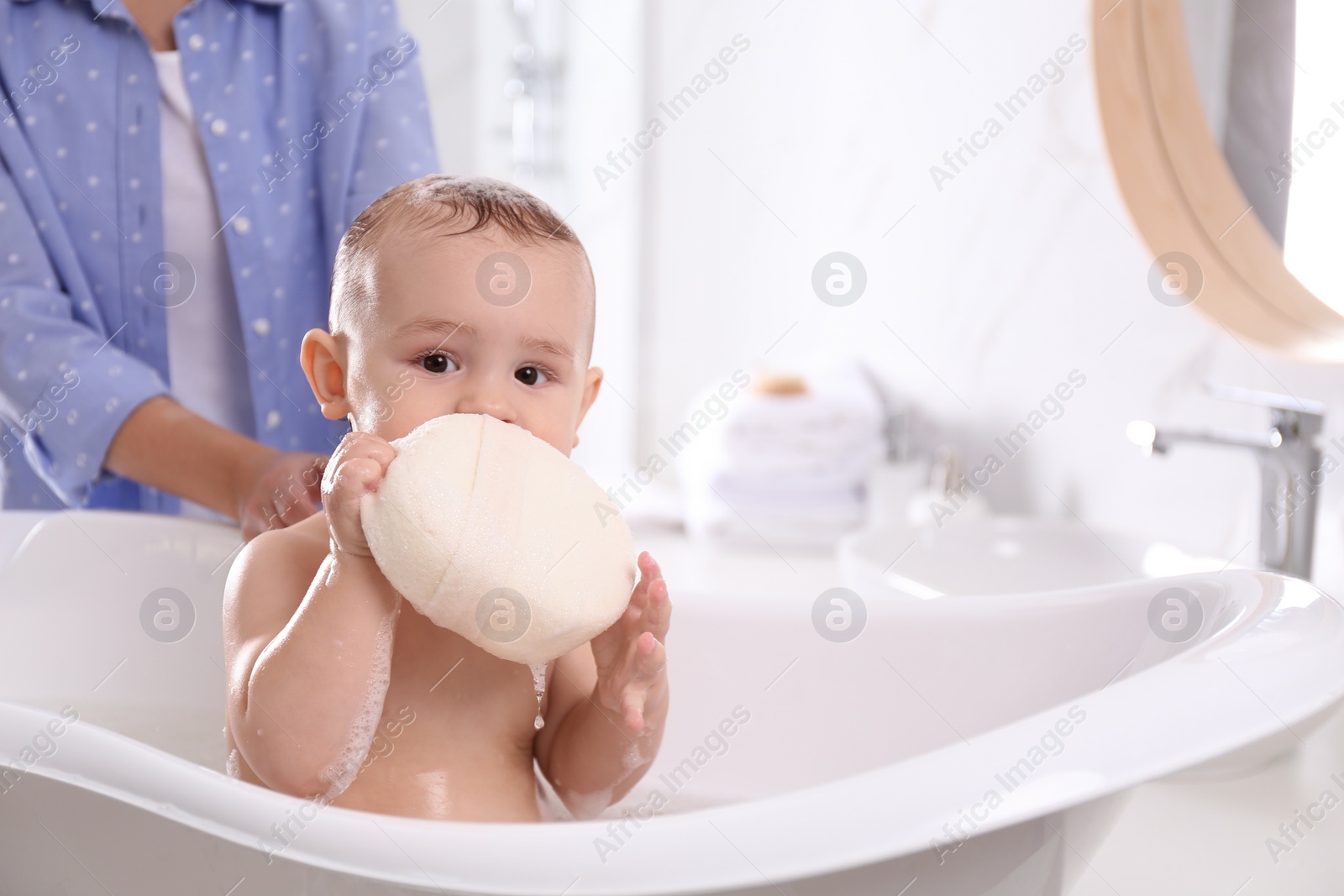 Photo of Mother with her little baby in bathroom