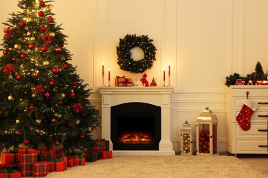 Photo of Cozy living room with Christmas tree near fireplace. Interior design