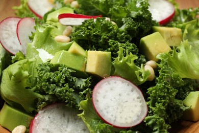 Photo of Delicious salad with kale leaves as background, closeup