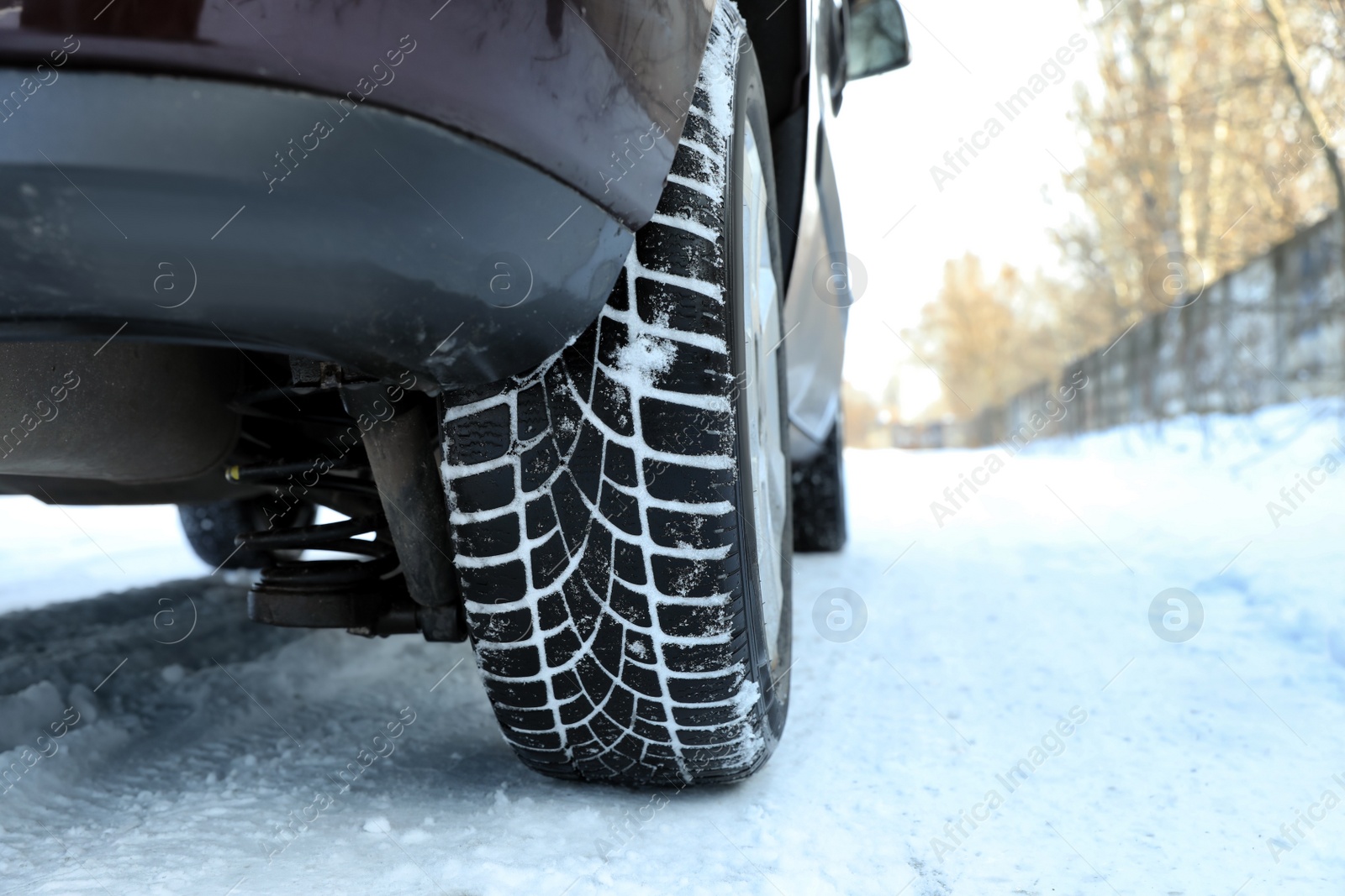 Photo of Car with winter tires on snowy road, closeup view