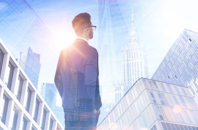 Double exposure of businessman and different buildings in city