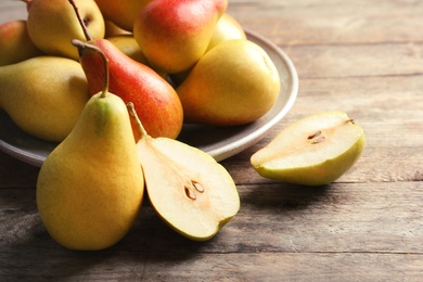 Photo of Ripe pears on wooden table. Healthy snack