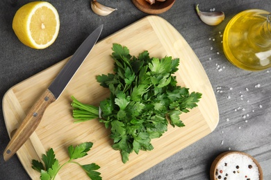 Photo of Flat lay composition with fresh green parsley on grey table