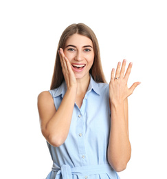 Photo of Happy young woman wearing beautiful engagement ring on white background