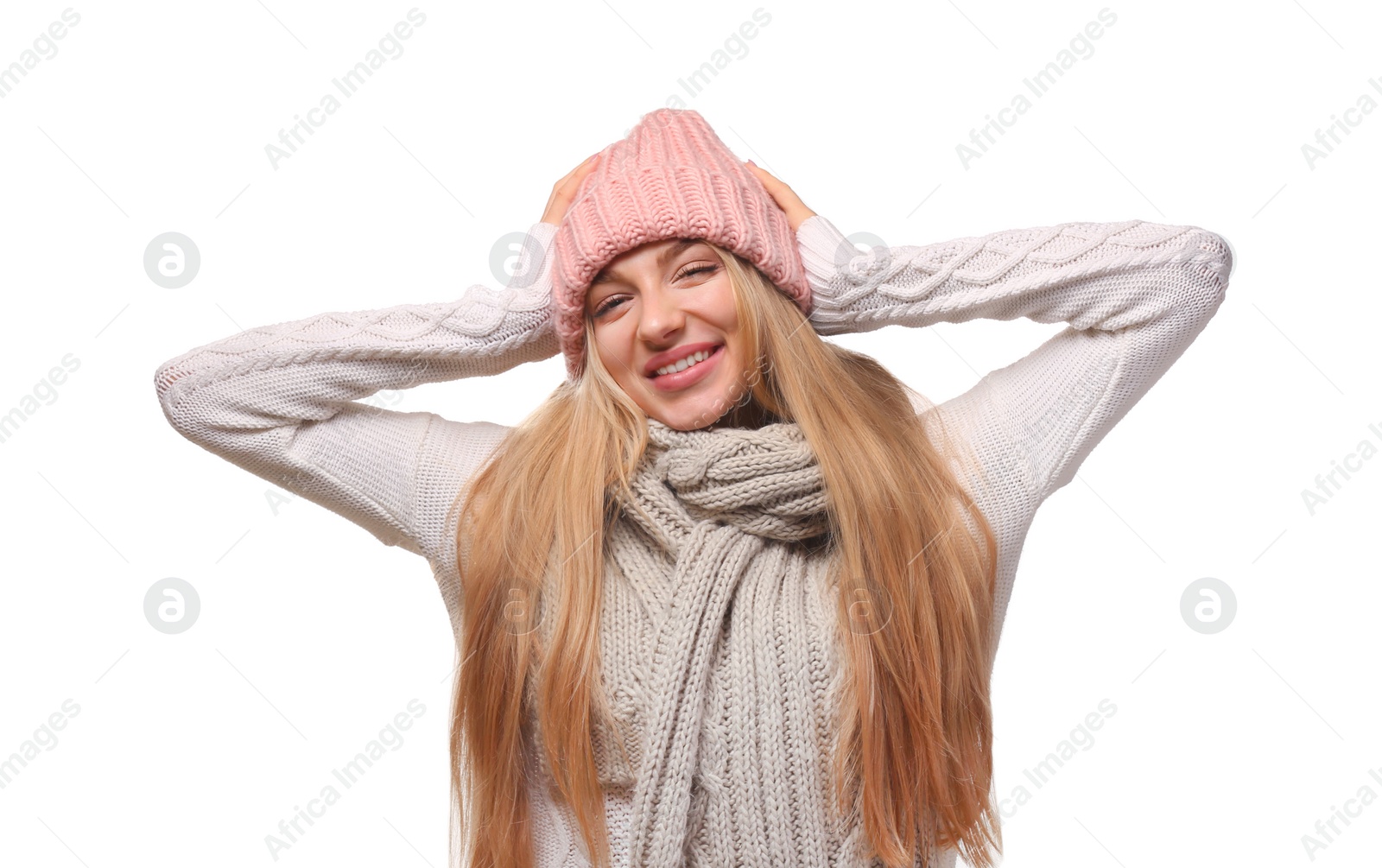 Photo of Portrait of emotional young woman in stylish hat and sweater with scarf on white background. Winter atmosphere