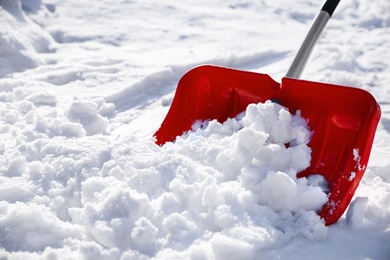 Photo of Shoveling snow outdoors on sunny winter day, closeup