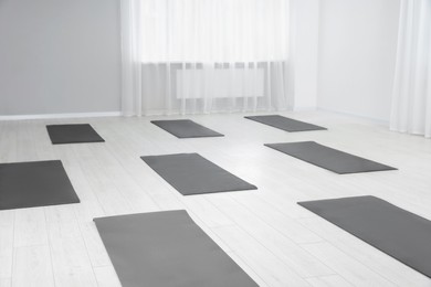 Spacious yoga studio with exercise mats on floor