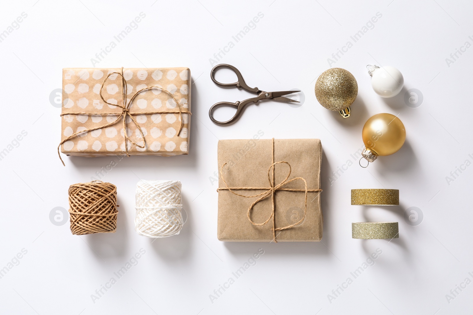 Photo of Composition with scissors and gifts on white background, top view