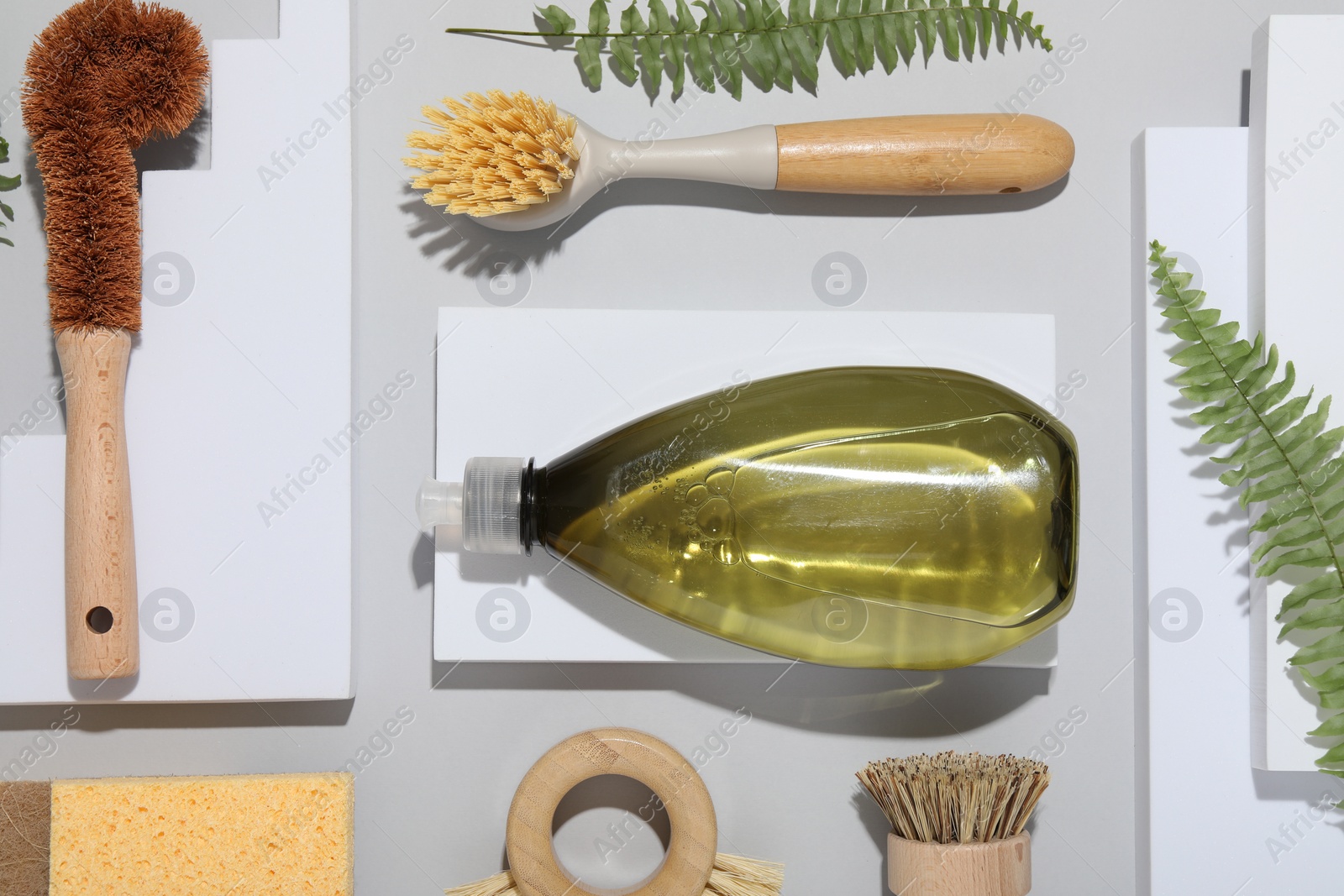 Photo of Flat lay composition with different cleaning supplies on light gray background