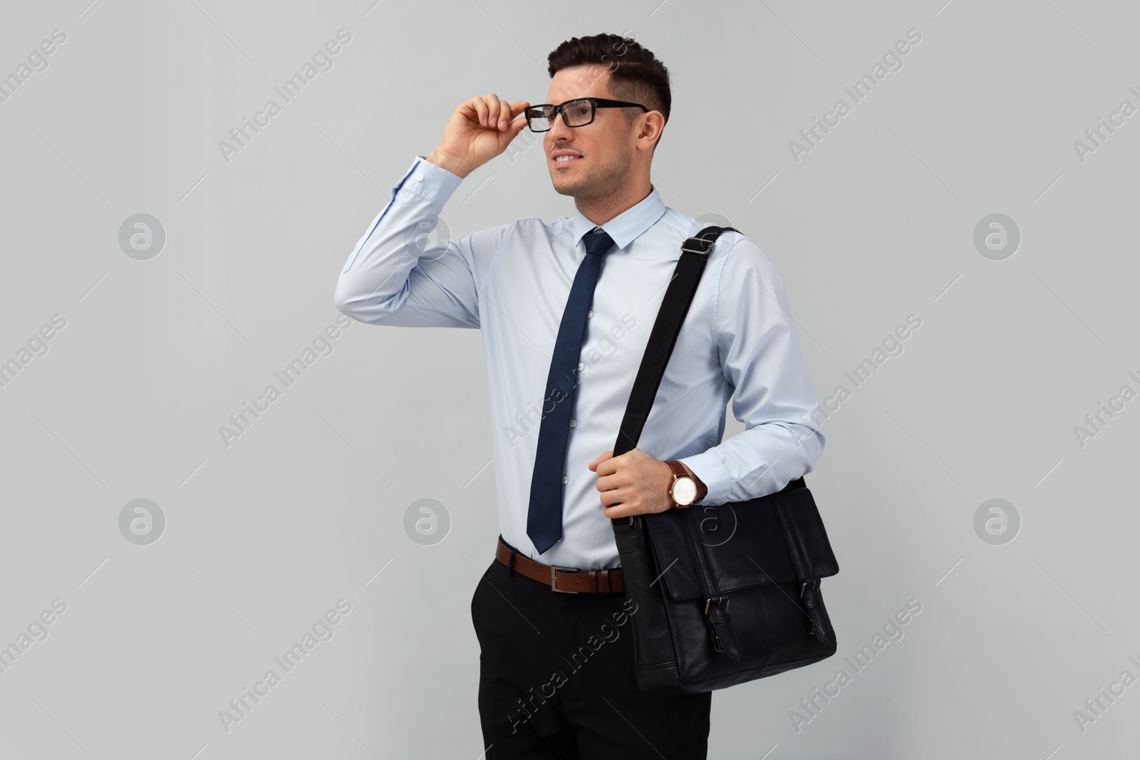 Photo of Businessman with stylish leather briefcase on light background