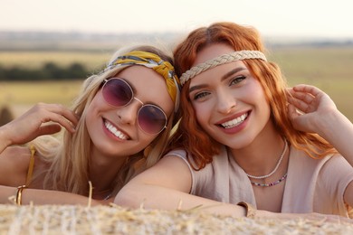 Portrait of beautiful happy hippie women in field